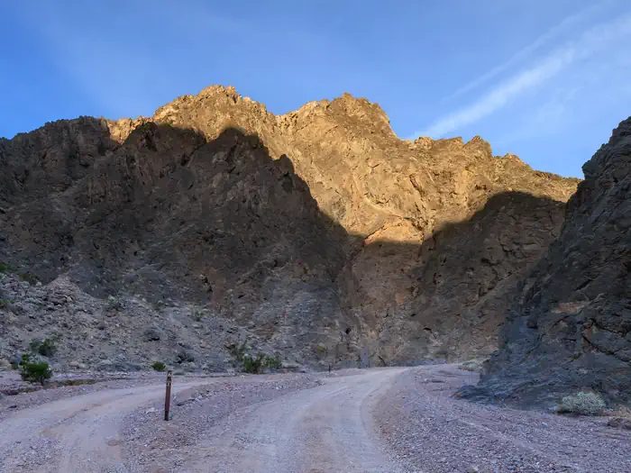 Gravel dirt road with a parallel roadside campsite along Echo Canyon Road