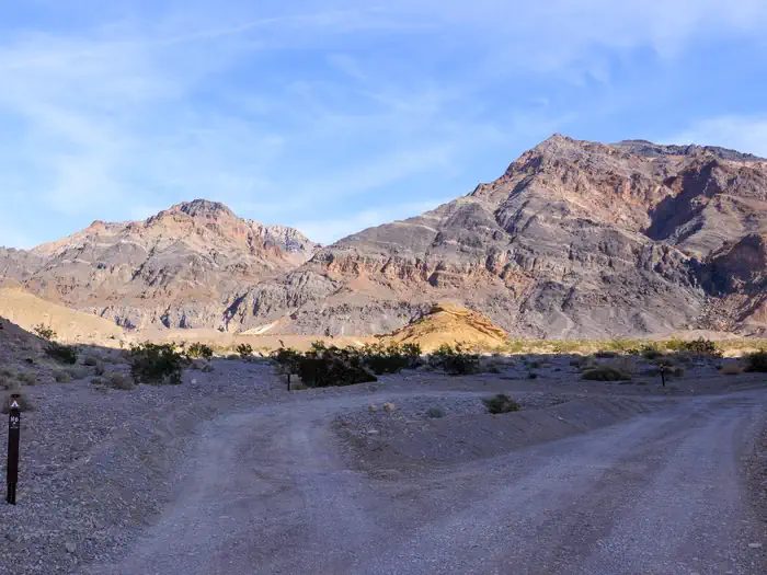 Gravel dirt road with parallel roadside campsite along Hole in the Wall Road