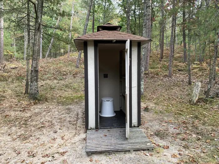pit toilet with door open
