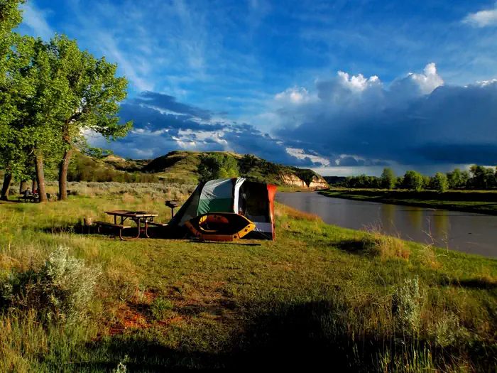 A tent pitched with a view of the Little Missouri River
