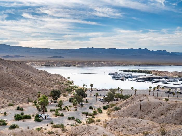 Cottonwood Cove Campground's paved loop below the desert hills, with Lake Mohave and the Cottonwood Cove marina behind