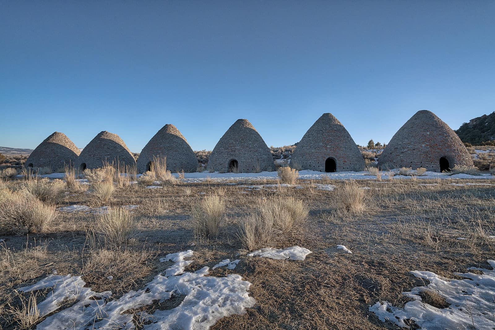 All six Ward charcoal ovens in a row on a winter morning, the park's centerpiece near Willow Creek Campground