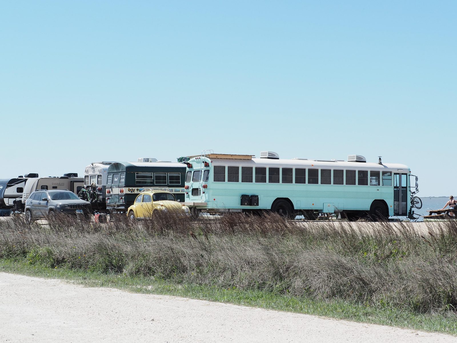 Converted school buses are parked at Bird Island Basin Campgound